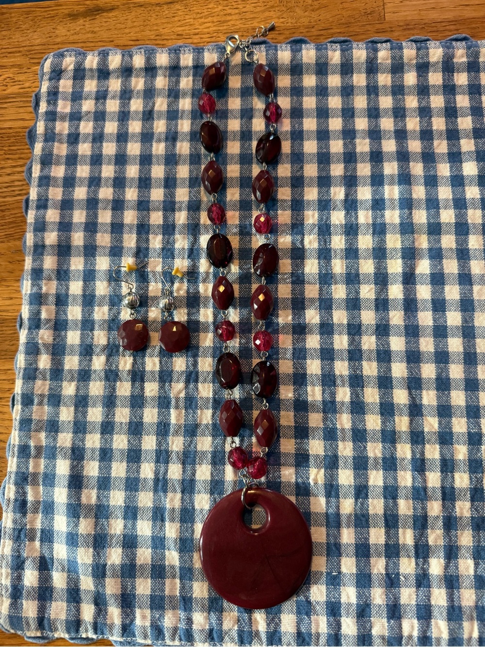 Necklace , red beaded multi- shaped w/large circular open pendant & earrings